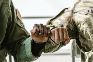 Two military members fist bumping